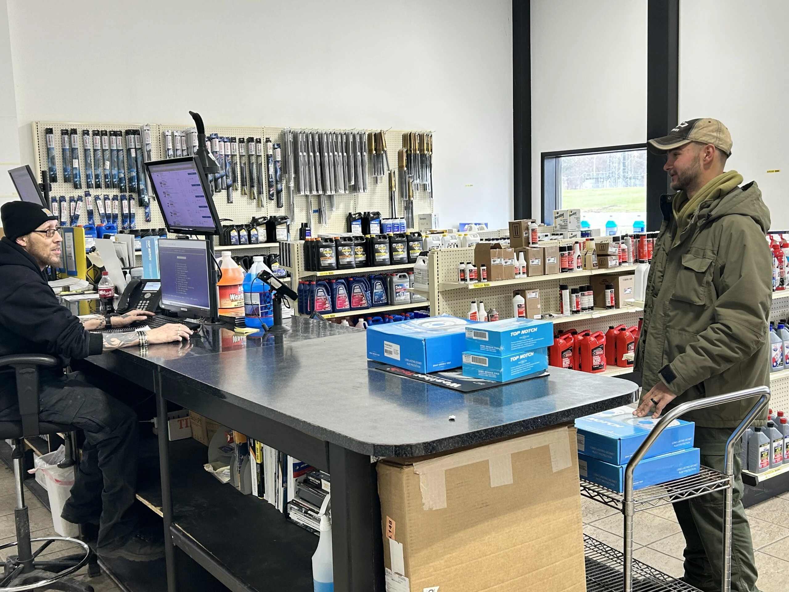 A customer and employee interacting over the counter at the United Auto Supply store in Cicero.