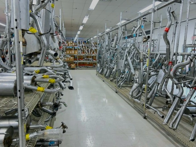 Rows of racks containing exhausts that are stocked in the United Auto Supply store in Cortland.