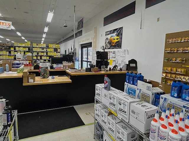 A view of the sale floor and customer counter where an employee is sitting ready to assist someone.